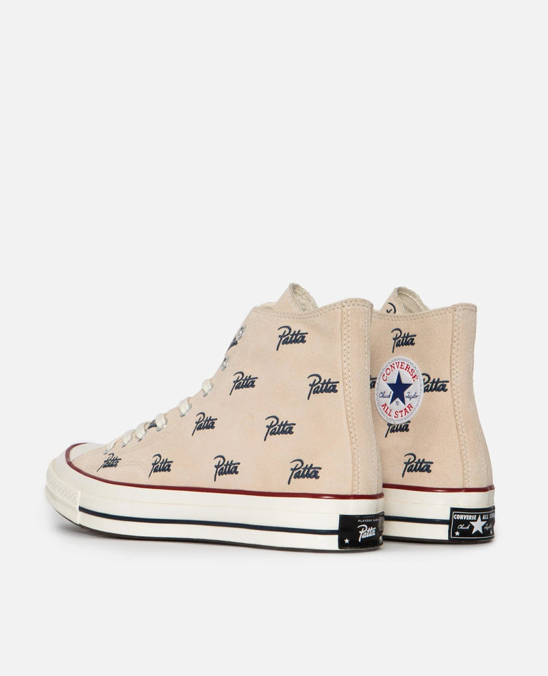 Patta x Converse Chuck 70 Hi sneakers in natural ivory canvas with all-over blue logos, shown from the side and rear.