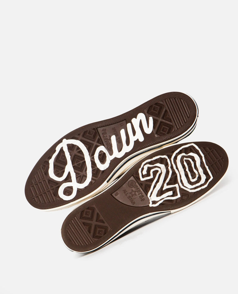 Brown rubber outsoles of Patta x Converse Chuck 70 Hi sneakers with white 20 Down lettering.