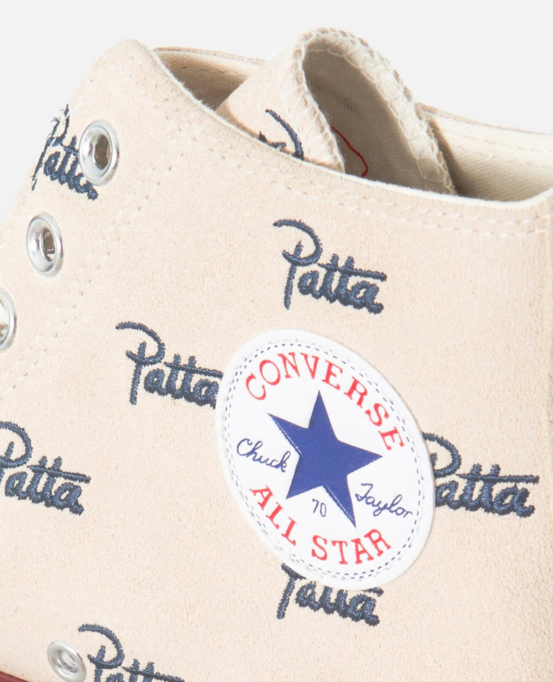 Close-up of Patta x Converse Chuck 70 Hi in natural ivory canvas with All Star patch and logo print.