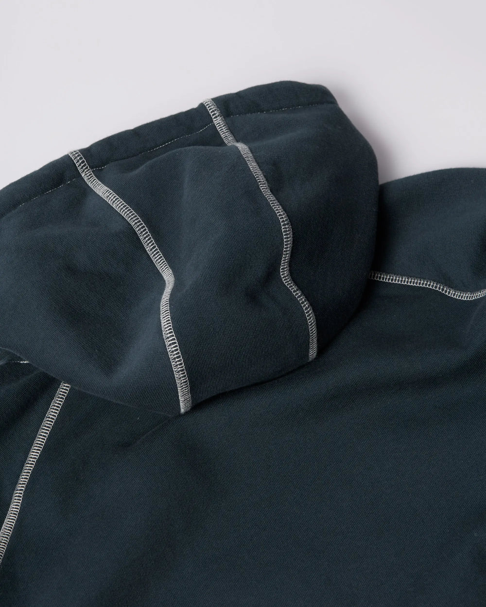 Hood detail of the dark blue byParra hooded sweatshirt featuring white contrast stitching.